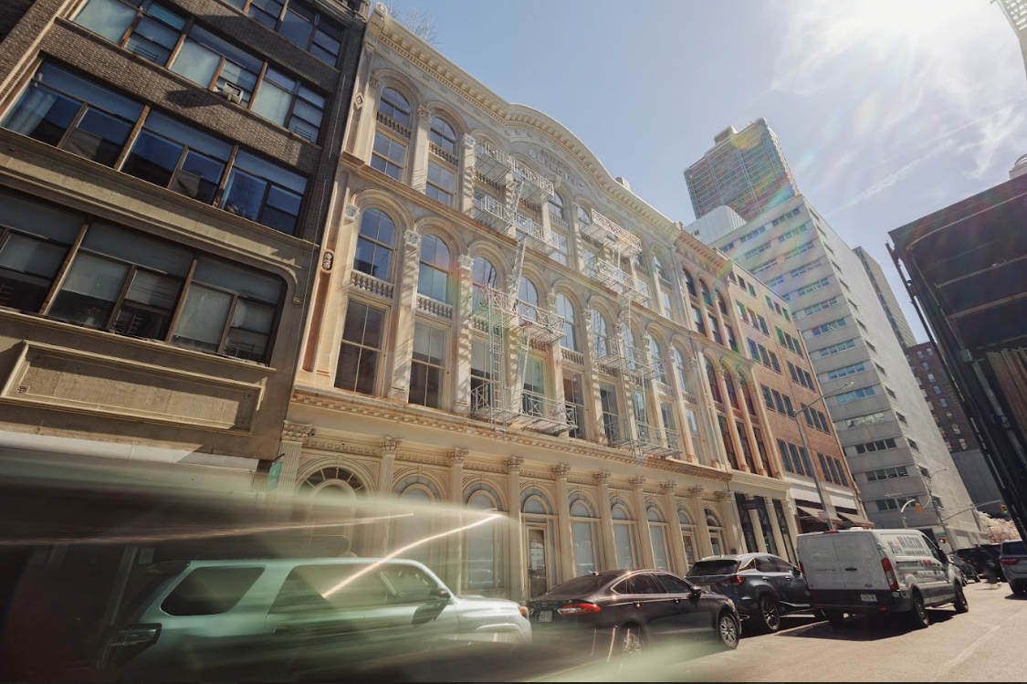 Dynamic street view of a historic building in a busy city.